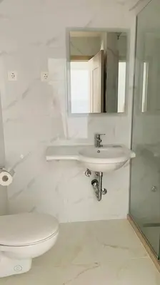 a bathroom with a sink and a toilet and a mirror at Lux studio apartment Bečići-Budva in Budva