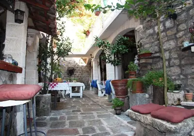 an alley in a house with a table and chairs at Best Location Old Town Budva Rooms in Budva