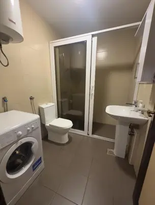 a bathroom with a washing machine and a sink at Studio center Budva in Budva