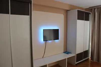 a living room with a tv on a wall at Studio center Budva in Budva