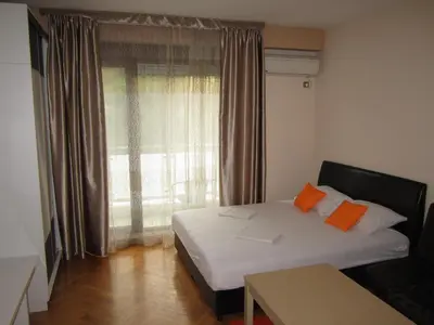 a small bedroom with a bed and a window at Studio center Budva in Budva