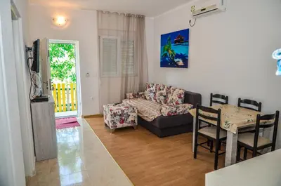 a living room with a couch and a table at Apartments Paradise in Ulcinj