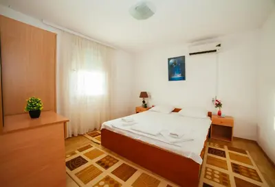 a bedroom with a bed and a window at Apartments Paradise in Ulcinj