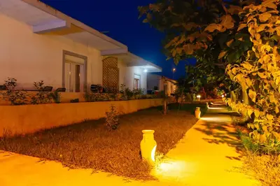a house with a yellow vase on the side of a street at Apartments Paradise in Ulcinj