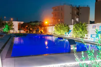a swimming pool at night with blue illumination at Apartments Paradise in Ulcinj