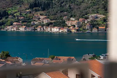 a view of a lake with a boat in the water at Bonita Residence in Dobrota