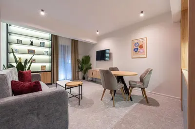 a living room with a table and chairs at Bonita Residence in Dobrota