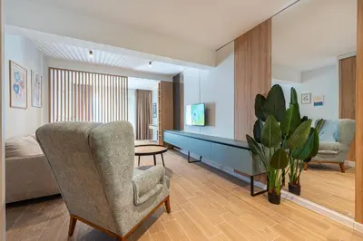a living room with a chair and a couch at Bonita Residence in Dobrota