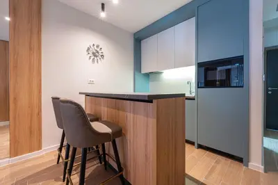 a kitchen with a counter and a chair in a room at Bonita Residence in Dobrota
