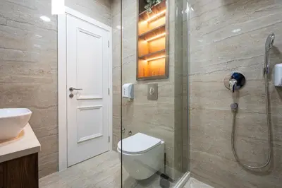 a bathroom with a toilet and a glass shower at Bonita Residence in Dobrota