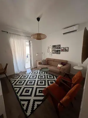 a living room with a couch and a rug at Lamada One Bedroom Apartment in Budva