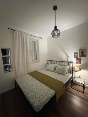 a bedroom with a bed and a pendant light at Lamada One Bedroom Apartment in Budva
