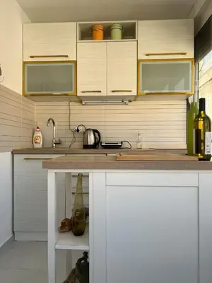 a kitchen with white cabinets and a counter top at Lamada One Bedroom Apartment in Budva