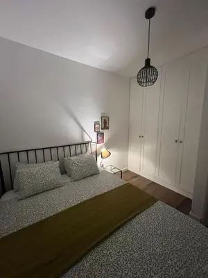 a bedroom with a bed and a pendant light at Lamada One Bedroom Apartment in Budva