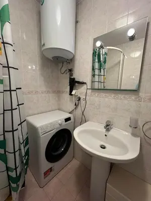 a bathroom with a washing machine and a sink at Lamada One Bedroom Apartment in Budva
