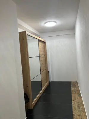 a room with a sliding door and a hallway at Cezar Apartment 3 in Podgorica