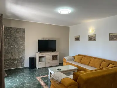 a living room with a couch and a flat screen tv at Cezar Apartment 3 in Podgorica