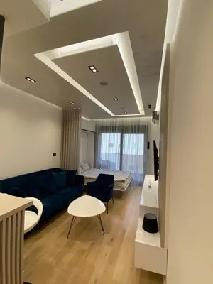 a living room with a blue couch and a table at Blue View Luxury Apt in Soho City in Bar