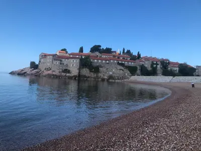 a group of buildings on the shore of a body of water at Apartment Skada in Sveti Stefan
