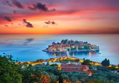 a view of a small island in the water at sunset at Apartment Skada in Sveti Stefan
