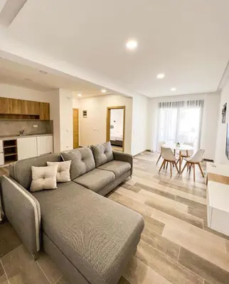 a living room with a couch and a table at Square Residence & Pool in Ulcinj