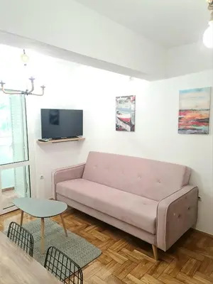 a living room with a couch and a table at Apartman GD in Budva