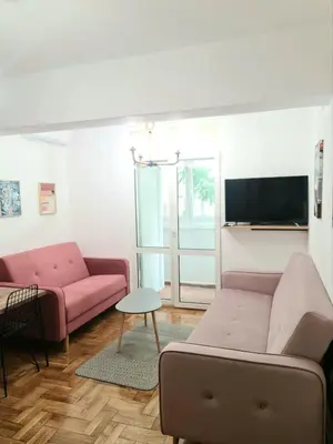 a living room with a couch and a tv at Apartman GD in Budva