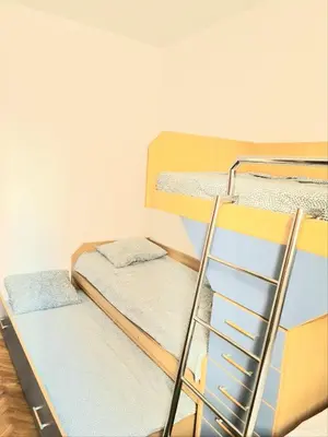 two bunk beds in a room with a ladder at Apartman GD in Budva