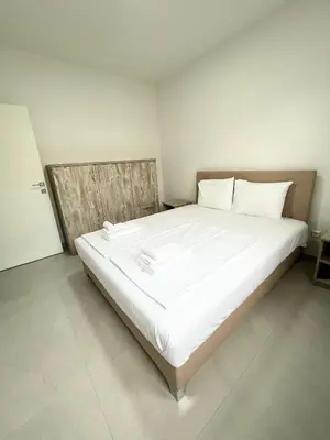 a large white bed in a white room at Miran San in Donji Štoj