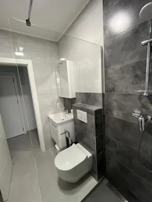 a bathroom with a toilet and a sink and a shower at Miran San in Donji Štoj