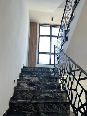 a staircase in a house with black stone stairs and a window at Miran San in Donji Štoj