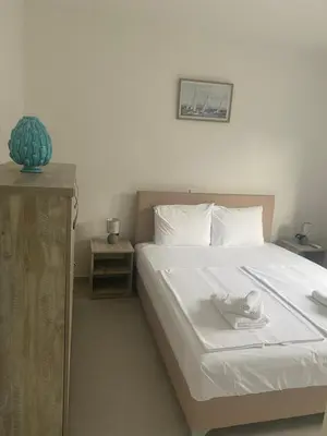 a bedroom with a large bed with white sheets at Miran San in Donji Štoj