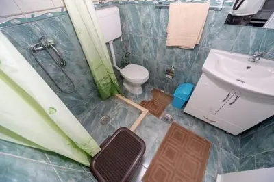 a bathroom with a shower and a toilet and a sink at Apartmani Murić Bar in Bar