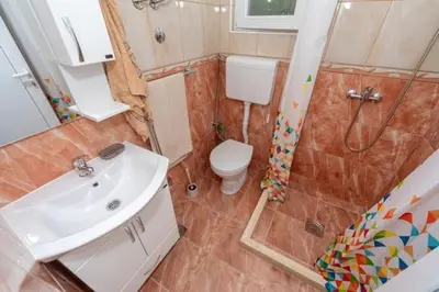 a bathroom with a toilet and a sink and a shower at Apartmani Murić Bar in Bar