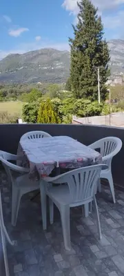 a table and two chairs on a patio with a view at Apartmani Murić Bar in Bar