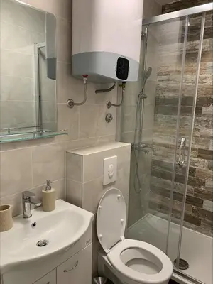 a bathroom with a shower and a toilet and a sink at Popi in Budva