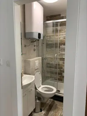a bathroom with a toilet and a sink and a shower at Popi in Budva