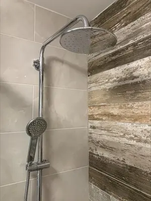 a shower with a shower head in a bathroom at Popi in Budva