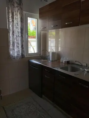 a kitchen with a sink and a window at Popi in Budva