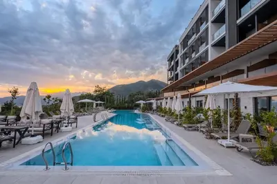 a pool at a hotel with chairs and umbrellas at Montenegro Lodge in Tivat