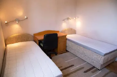 a room with two beds and a desk and a desk at Apartment Filip in Bar