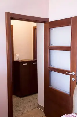a room with a door and a closet with a mirror at Apartment Filip in Bar