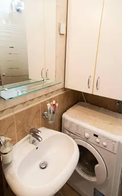 a bathroom with a sink and a washing machine at Apartment Filip in Bar