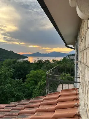 a balcony of a building with a view of the water at Lazarus Bigova apartments in Tivat