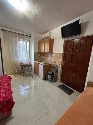 a living room with a bed and a kitchen at Lazarus Bigova apartments in Tivat