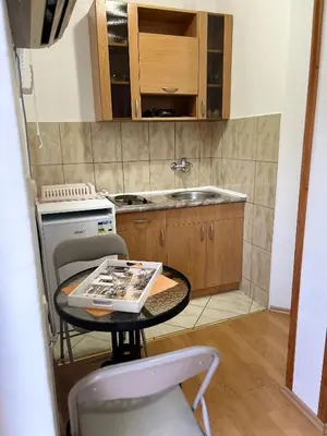 a small kitchen with a table and a stove at Lazarus Bigova apartments in Tivat