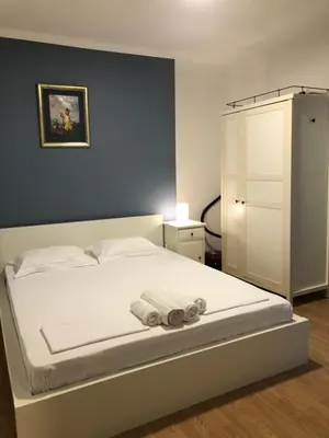a bedroom with a white bed with towels on it at Monika in Budva