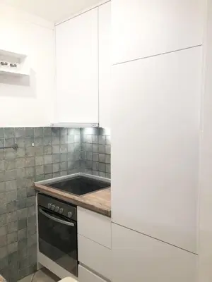 a kitchen with white cabinets and a stove at Monika in Budva