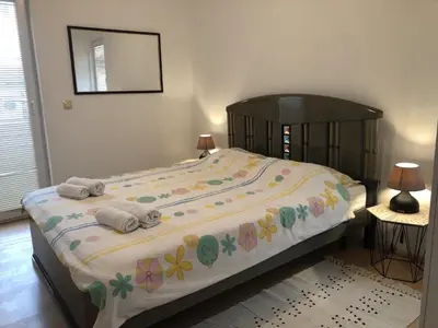 a bedroom with a large bed with towels on it at Monika in Budva