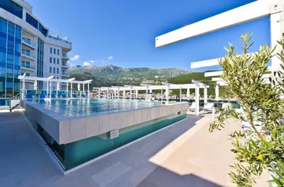 a swimming pool on the side of a building at Sea View Tre Canne Apartment in Budva